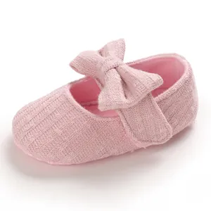 Soft-soled pink baby girl toddler princess shoes with a large decorative bow tie