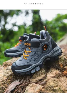 Macro view of warm fleece-lined outdoor winter boots for boys with mountain pattern