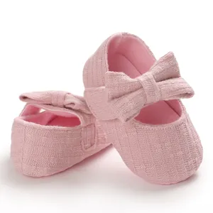 Close-up of pink baby princess shoes with soft soles and decorative bows for toddlers