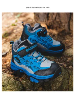 Macro detail of blue boys' winter snow boots with warm faux fur lining and mountain patterns.