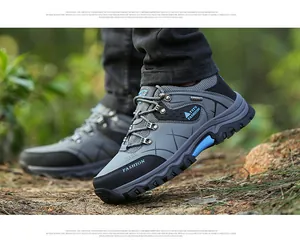 Detail of men's outdoor hiking shoes with durable rubber thick sole and blue accents