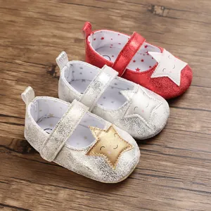 Vista detallada de zapatos metálicos para bebé con parches de estrellas y sonrisas.