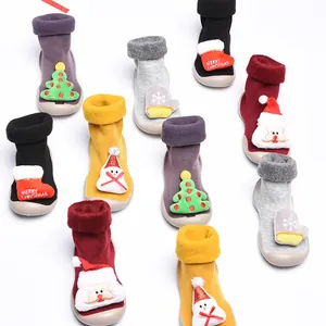 Group shot of Christmas themed baby sock shoes with cartoon plush decorations