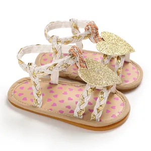 Close-up detail of baby girl summer sandals featuring glitter hearts and braided straps