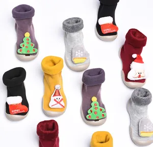 Detalle de calcetines con suela para niños con temática navideña y forro polar.