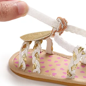 Close-up of hook-and-loop strap detail on baby girl's heart print summer sandals