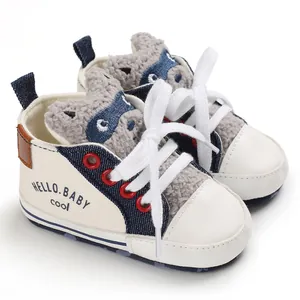 Close-up detail of white baby walking shoe featuring a cute cartoon raccoon tongue