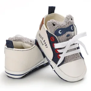 Detail showing cute raccoon character design on soft sole baby canvas walking shoes