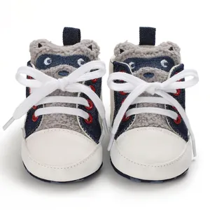Close-up of baby walking shoes with raccoon design and white soft sole