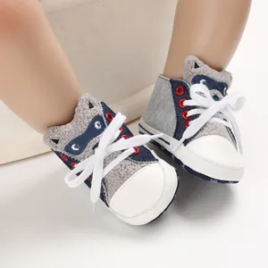 Close-up of baby walking shoes with cartoon raccoon design and soft fleece texture