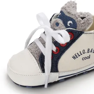 Close-up view of infant walking shoe featuring soft leather toe and cute cartoon animal