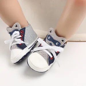 Close-up detail of cute cartoon raccoon design on soft sole baby walking shoes