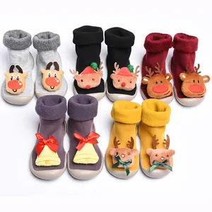 Detailed view of Christmas-themed toddler slipper socks with plush reindeer and bells