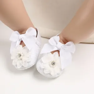 Detailed view of white lace baby princess walker shoes with elegant ribbon bow and flower