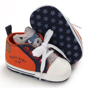 Detailed view of orange cartoon baby walker shoes with star pattern non-slip sole