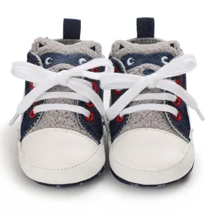 Front view of cute grey raccoon cartoon baby walking shoes with white laces and red eyelets