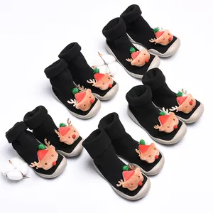 Detailed view of black Christmas baby sock shoes featuring plush 3D reindeer decorations