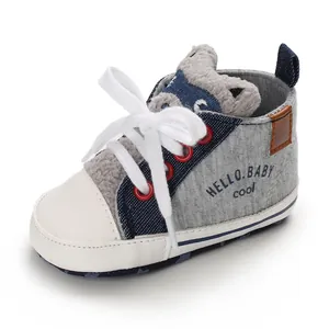 Close-up of baby walking shoe featuring a cute cartoon cat head and 'Hello Baby' print