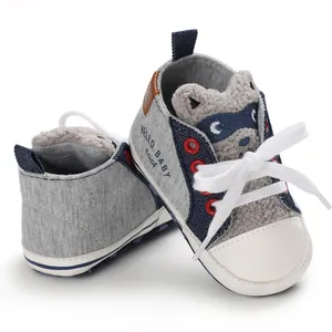 Close-up of baby pre-walker shoes with cute cartoon raccoon design and soft fabric sole