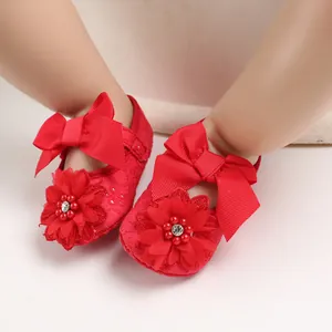 Close-up of red baby princess shoes featuring large bows and exquisite flower accents