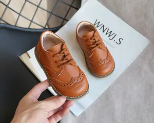 Detail view of brown toddler brogue shoes with classic wingtip perforated patterns
