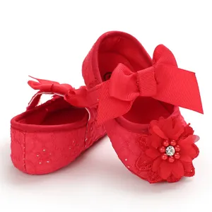 Detailed view of red infant princess shoes with grosgrain bow and floral bead accent