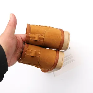 Close-up of warm brown suede children's snow boots with soft plush lining.