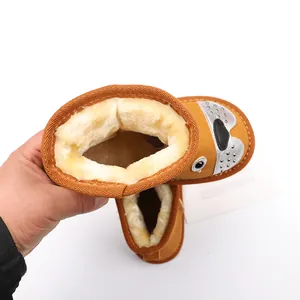 Top view of brown children snow boots showing thick warm faux fur lining and cute dog face