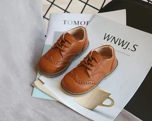 Detail shot of brown children's brogue shoes with classic wingtip perforation design