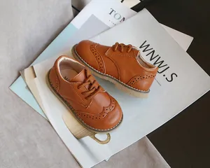 Classic brown children's leather oxfords with elegant brogue perforation details