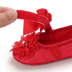 Macro detail of red baby girl princess shoe with floral bow and Velcro closure