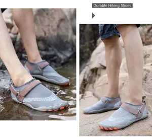 Detail of grey men's quick-dry water shoes worn on rocky stream bank