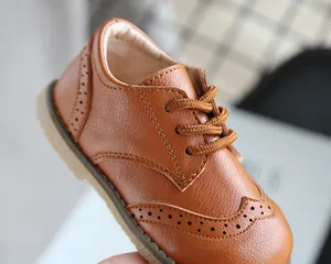 Close-up of brown children's Brogue shoes showing detailed stitching and leather texture.