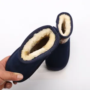 Close-up detail showing the thick warm faux fur lining of blue children's winter snow boots.