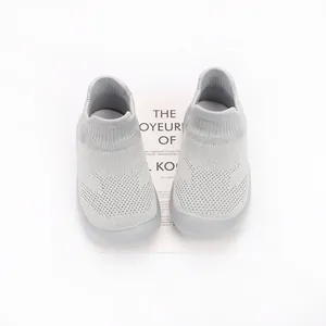 Detailed top-down view of breathable grey knit baby sock shoes with flexible rubber soles