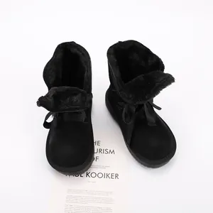 Top view of black children's snow boots with warm faux fur lining and ribbon bow detail.