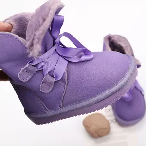 Detailed view of purple children's cow suede snow boots with soft faux fur lining
