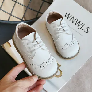 Classic white children's brogue leather shoes with lace-up design and soft soles