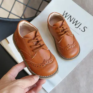 Classic brown children's leather brogue shoes with elegant perforated detailing for kids