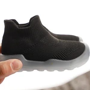 Detailed side view of breathable black kids sock shoes with flexible grey translucent sole