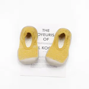 Detailed top view of yellow knit baby sock shoes with breathable and soft rubber soles