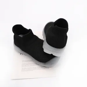 Detailed view of breathable black knit baby sock shoes with flexible translucent soles