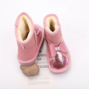Stylish pink toddler snow boots with glitter bow details and warm faux fur lining