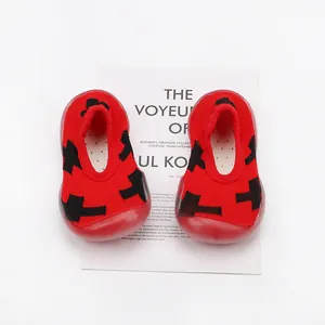 Close-up detail of red breathable baby sock shoes with soft non-slip soles for active toddlers.