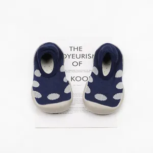 Detailed top view of navy polka dot knit baby walking shoes with soft rubber soles