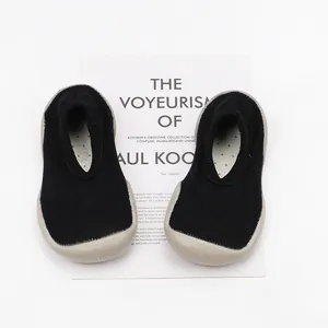 Black knit baby sock shoes with grey soft rubber sole for indoor walking
