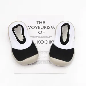 Breathable black and white baby sock shoes with soft rubber soles for walking.