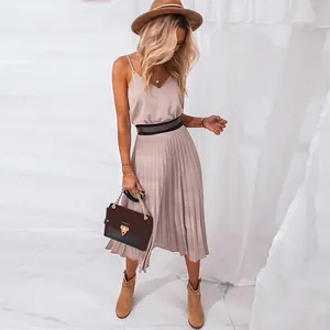 Detailed view of elegant V-neck pleated midi dress with a stylish waist belt accessory