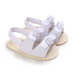 White baby summer sandals with double bow knots and soft breathable sole for infants.