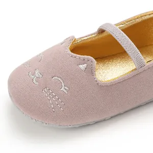 Macro view showing cute cat face embroidery on pink soft-soled breathable infant walking shoes